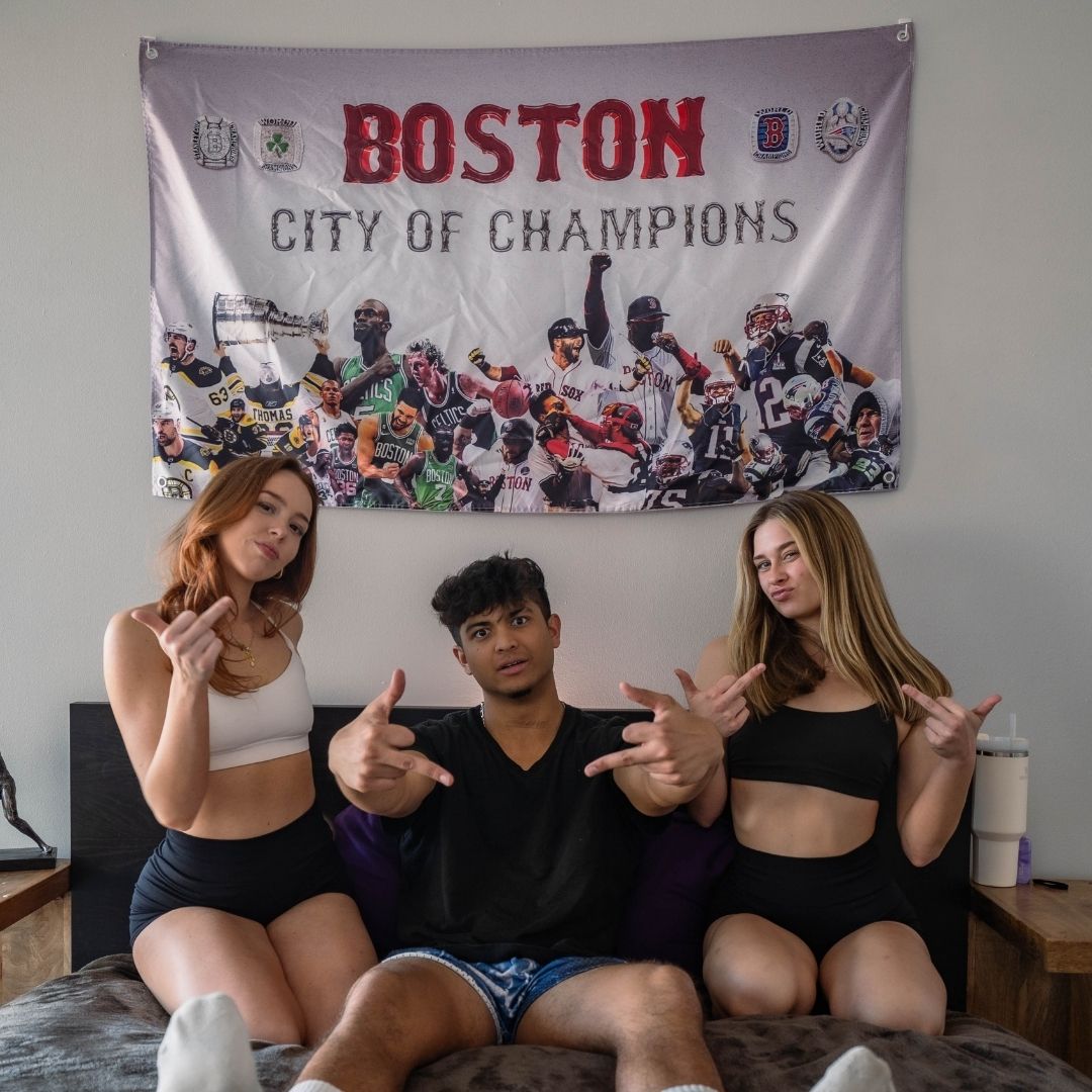College students in dorm room with Boston sports flag, celebrating the city's sports legacy