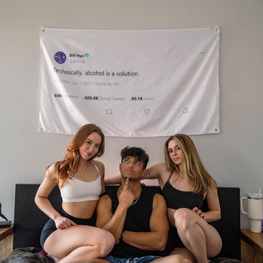 College students with a humorous Bill Nye tweet flag, adding a witty touch to dorm room decor