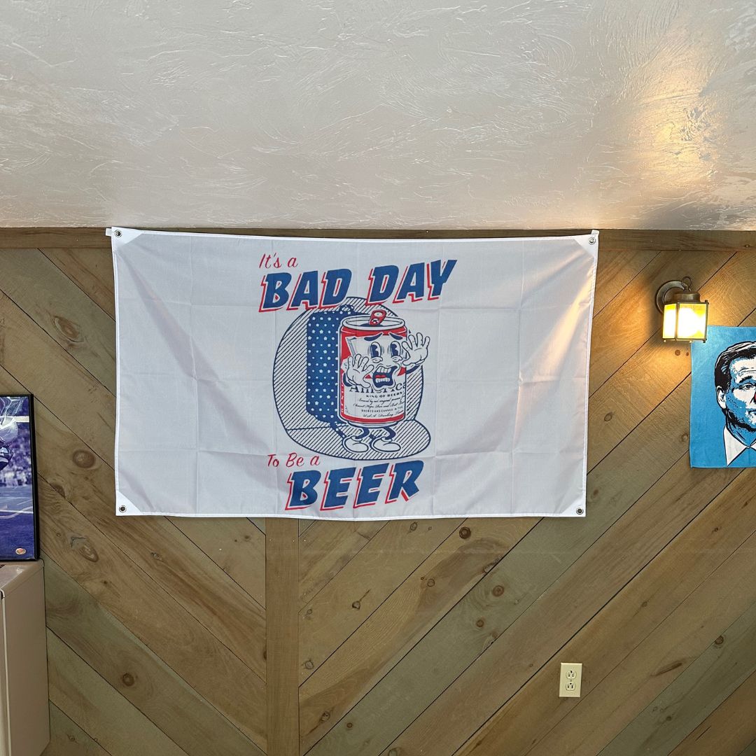 'It's a Bad Day to Be a Beer' flag displayed in a cozy room, adding a humorous touch to the decor, perfect for party enthusiasts and casual settings
