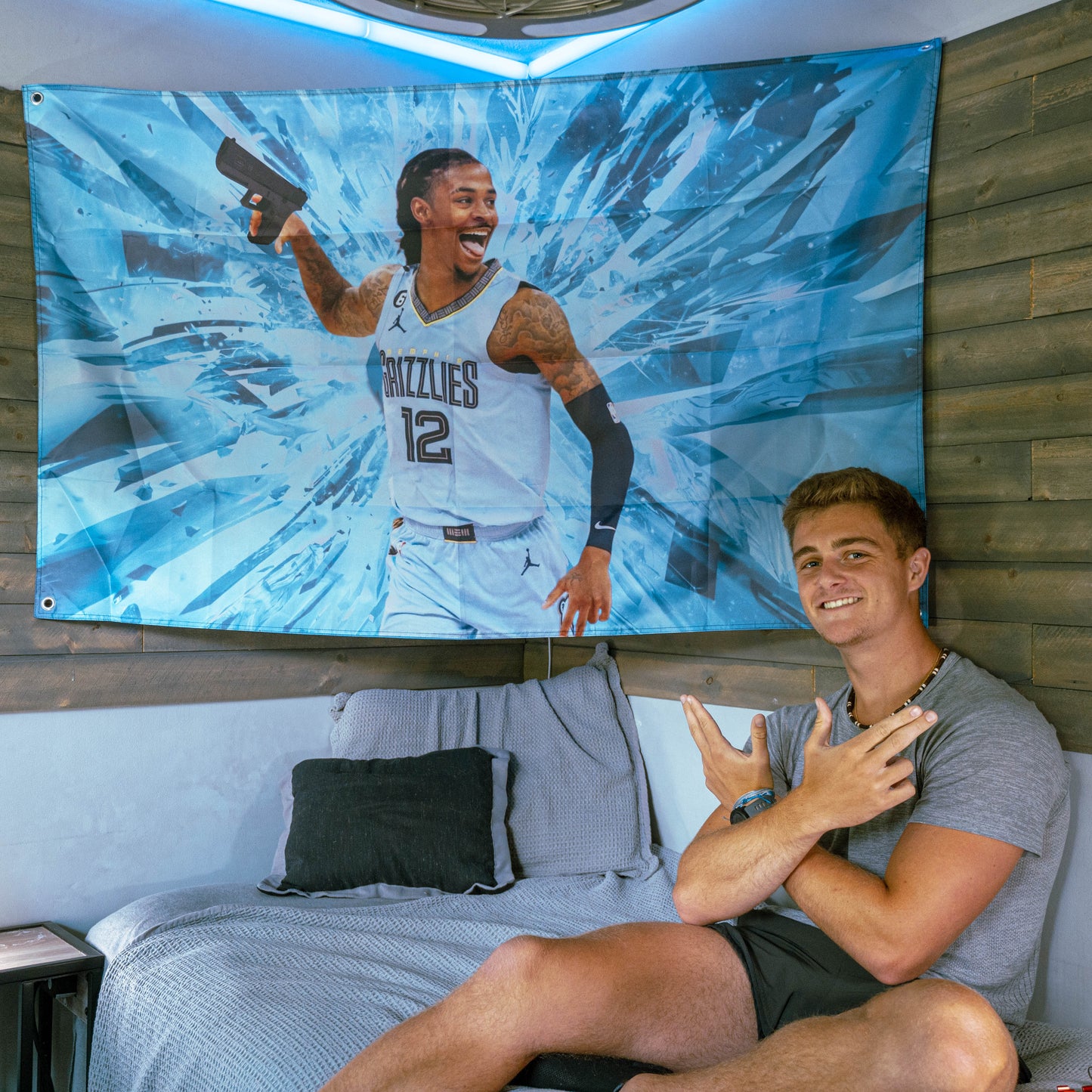 guy smiling in front of ja morant flag