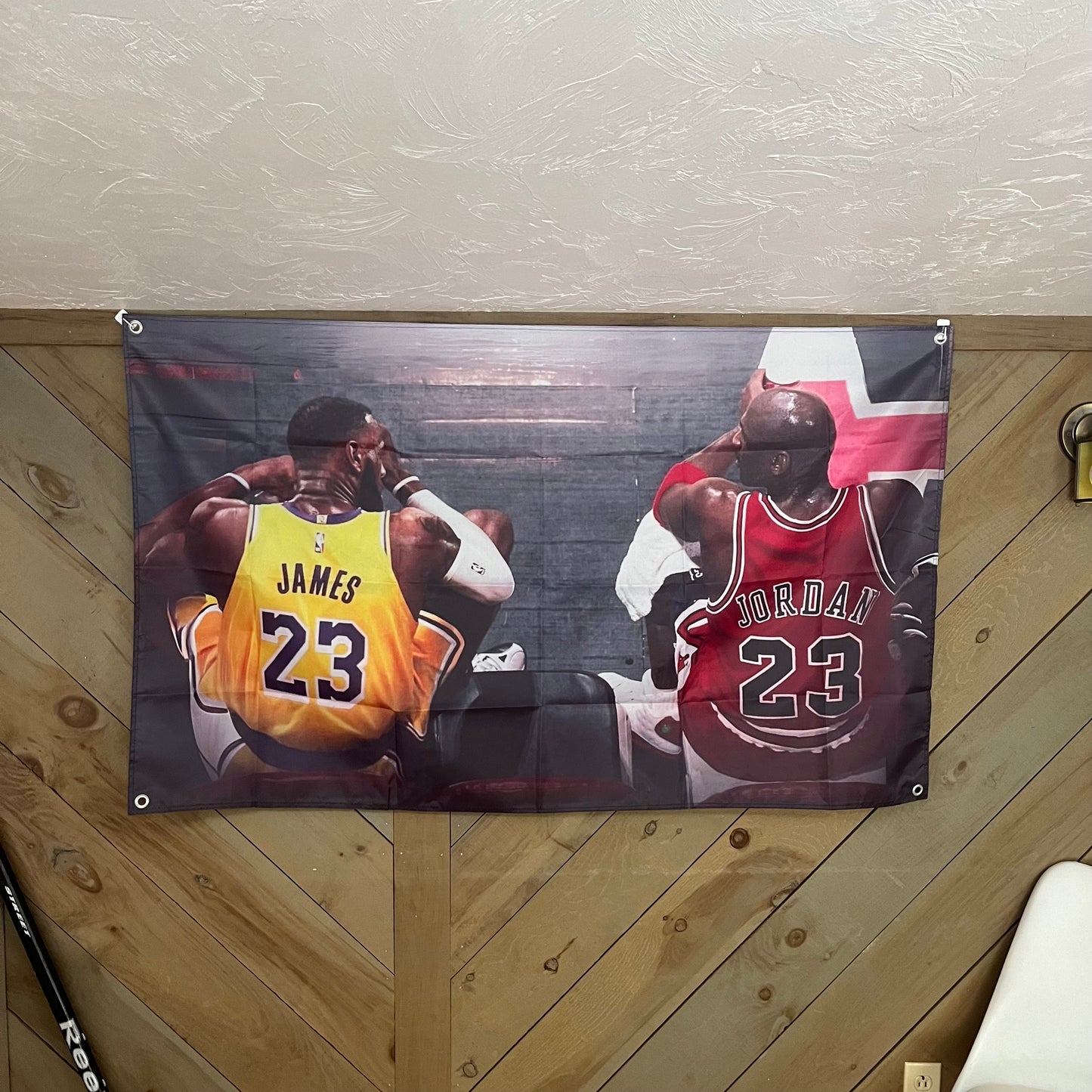 MJ & LeBron flag displayed in a stylish room, adding a touch of inspiration and admiration for basketball greatness, ideal for sports fans looking to enhance their space with iconic decor.