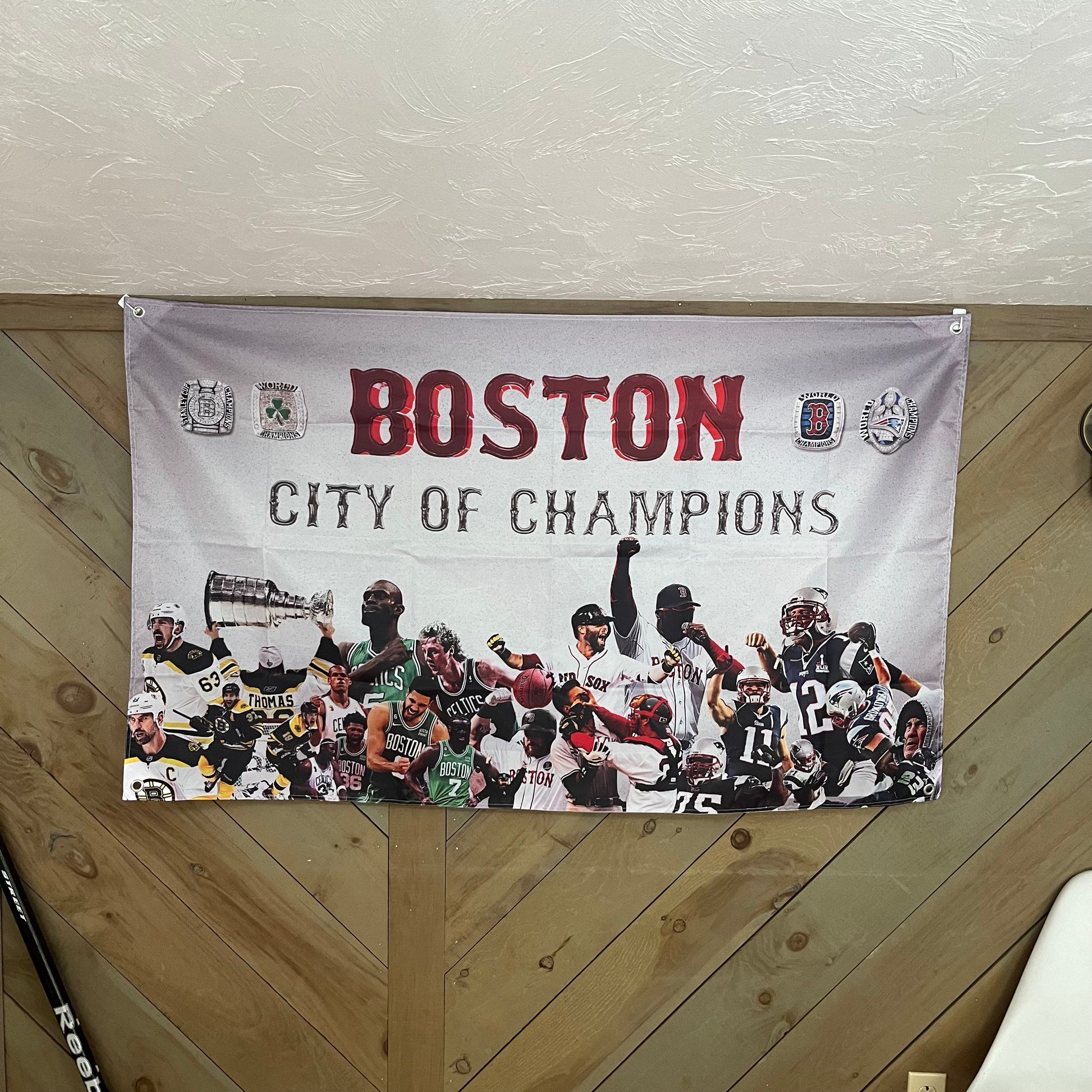Boston City of Champions flag displayed in a stylish room, celebrating the city's rich sports heritage, perfect for dedicated Boston sports fans and mancave decor.
