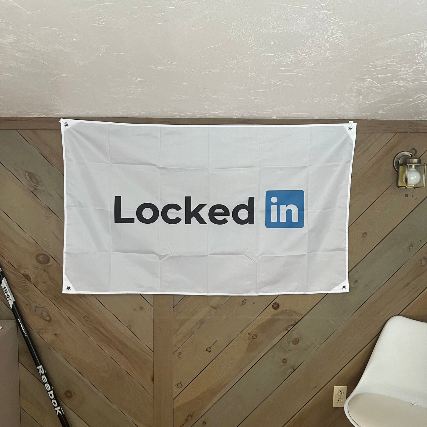 "Locked In" flag displayed in a contemporary room, highlighting its humorous take on the LinkedIn logo, ideal for tech-savvy individuals and professionals.