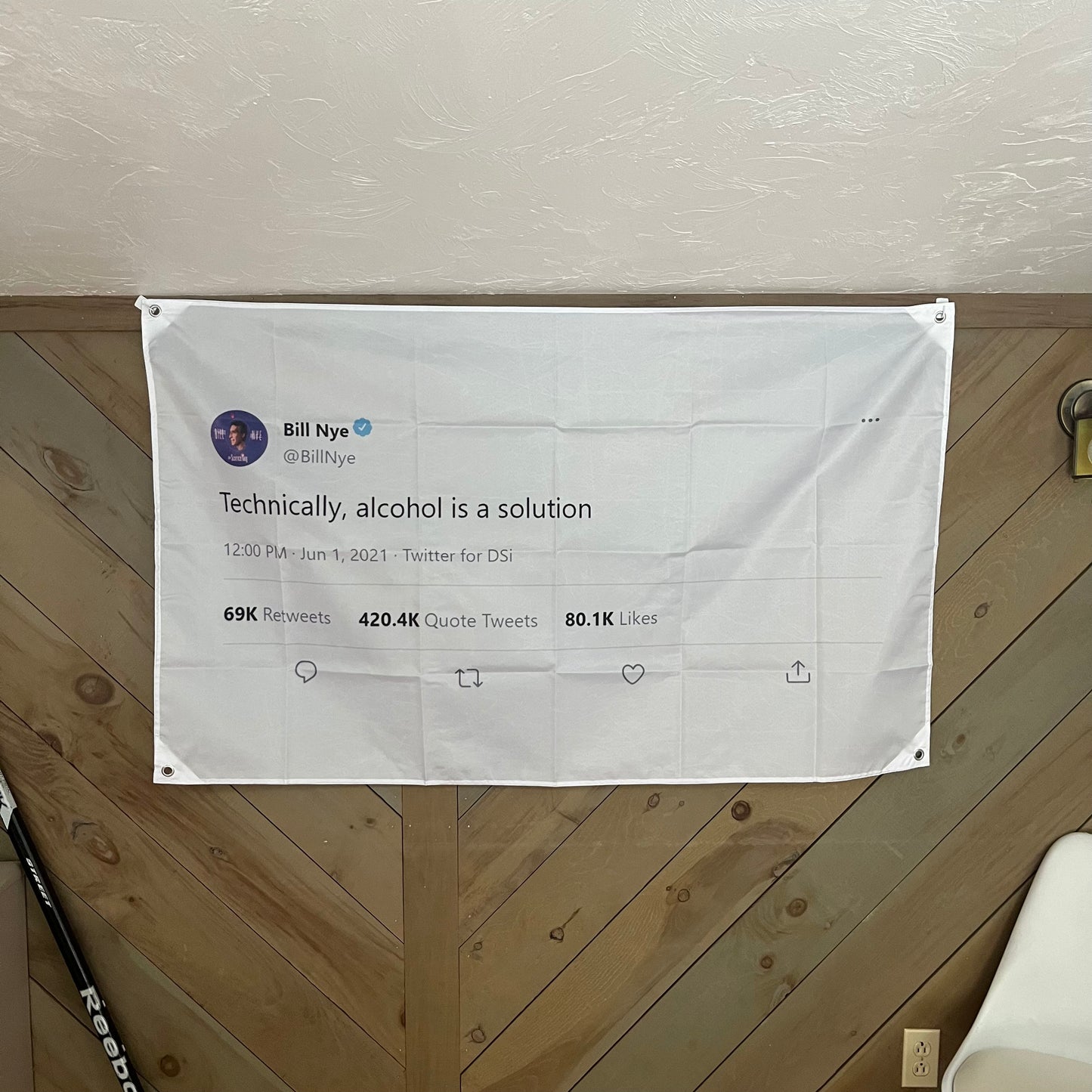 Bill Nye tweet flag displayed in a stylish room, adding a playful and scientific touch to the decor, perfect for college dorm rooms and social gatherings