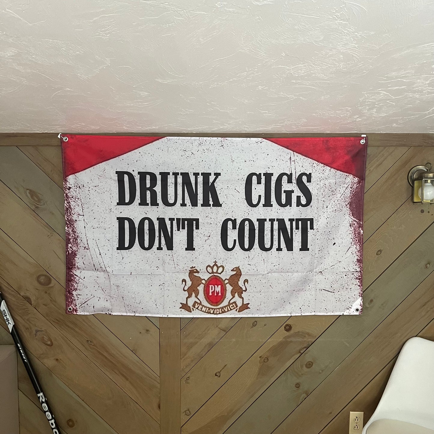 Drunk Cigs flag displayed in a cozy room, adding a humorous and edgy element to the decor, perfect for college dorms and party setups.