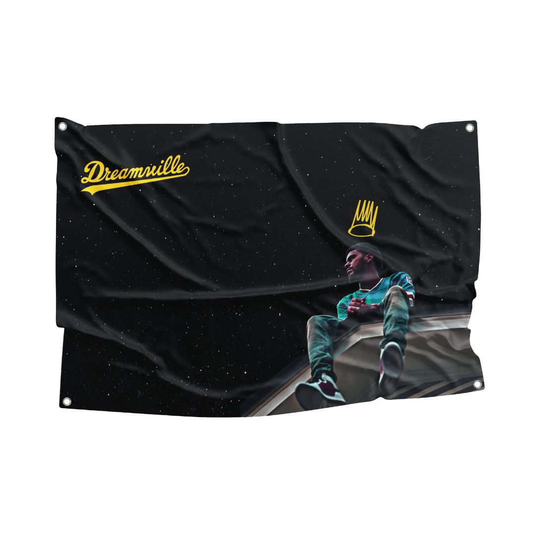 J. Cole Dreamville flag featuring a striking design with the artist sitting on a roof under a starry sky, wearing casual attire, with the Dreamville logo and crown icon in yellow, perfect for hip-hop fans and urban decor enthusiasts.