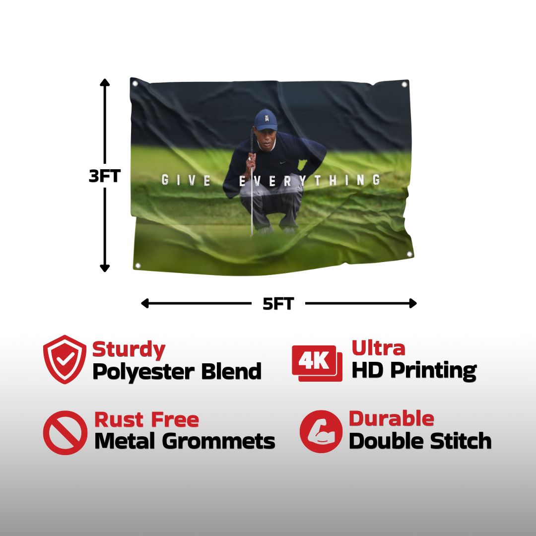 The "GIVE EVERYTHING" flag showcases a high-quality image of Tiger Woods printed on a sturdy polyester blend, equipped with ultra HD printing, rust-free metal grommets, and durable double stitching.