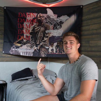 college guy in front of kendrick lamar flag