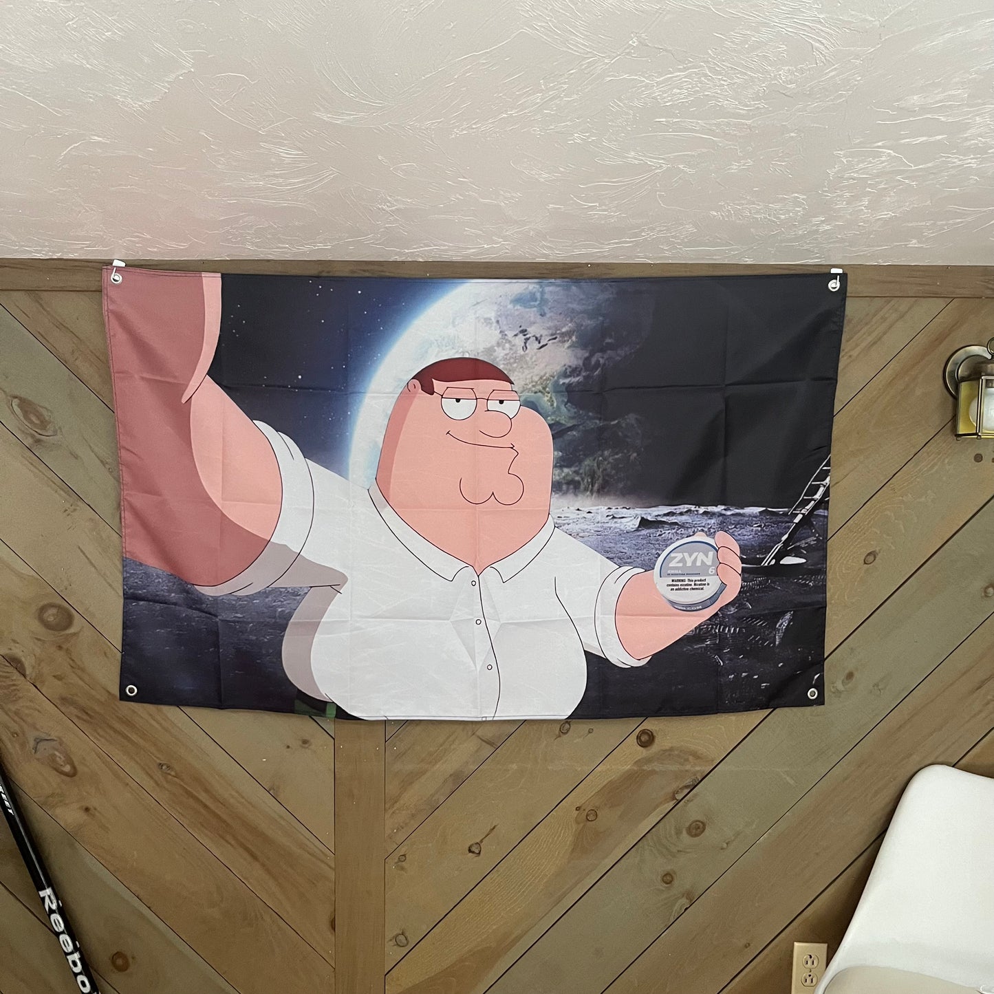 Room decor featuring the Peter Griffin holding a Zyn can flag, adding a touch of humor and quirkiness, perfect for fans of animated shows.