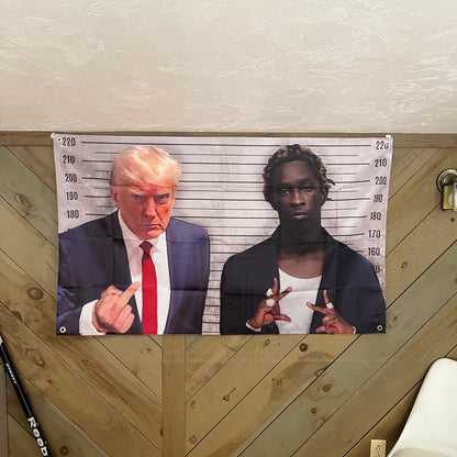 Humorous flag featuring Young Thug and Donald Trump in a mock mugshot. Young Thug displays hand signs, while Trump gives a defiant gesture. The height chart background adds to the playful, rebellious theme, making it an eye-catching decoration for fans of both pop culture and political satire.