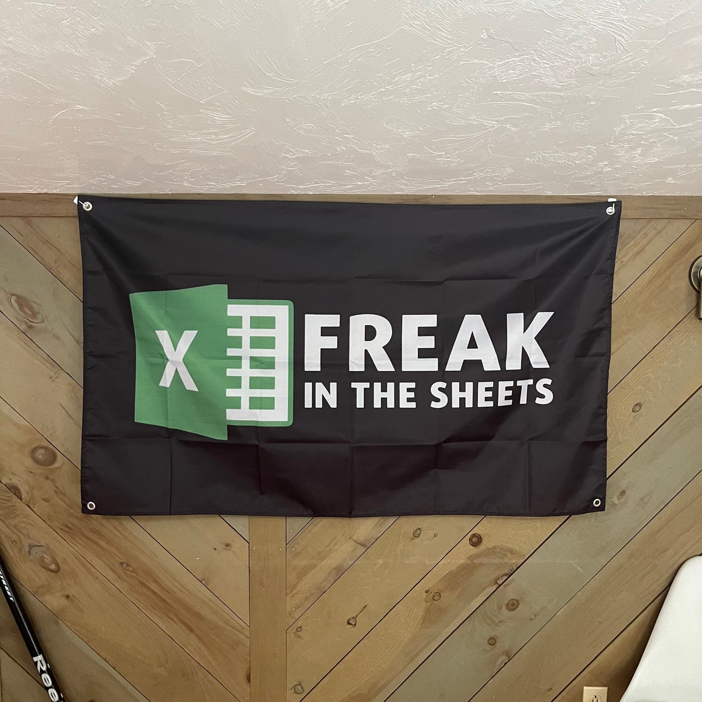 Freak in the Sheets flag displayed in a stylish room, emphasizing the clever Excel-themed design, perfect for tech-savvy individuals and office decorations.