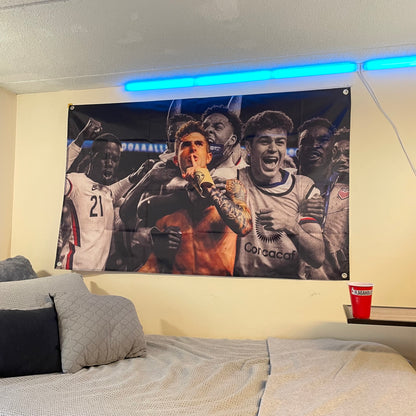 flag of christian pulisic celebrating after winning a soccer game hung up in a college dorm room